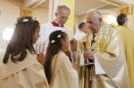 After offering instruction, pope gives first Communion to 245 children